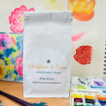 White product packaging with 'Wildflower & Ember' branding on a floral background