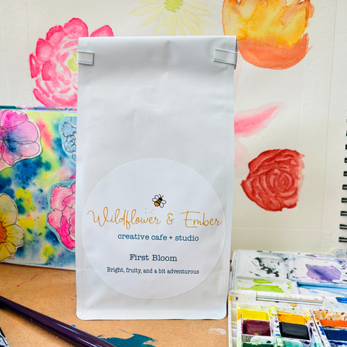 White product packaging with 'Wildflower & Ember' branding on a floral background